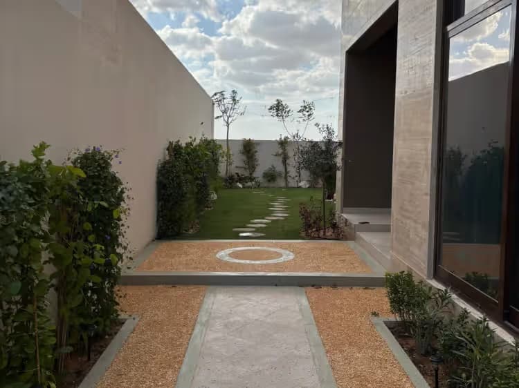 Modern gravel pathway landscape design with stepping stones