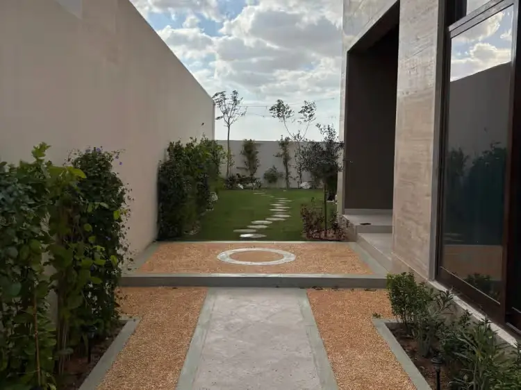Modern landscape design with a gravel pathway and stepping stones at a Dubai villa